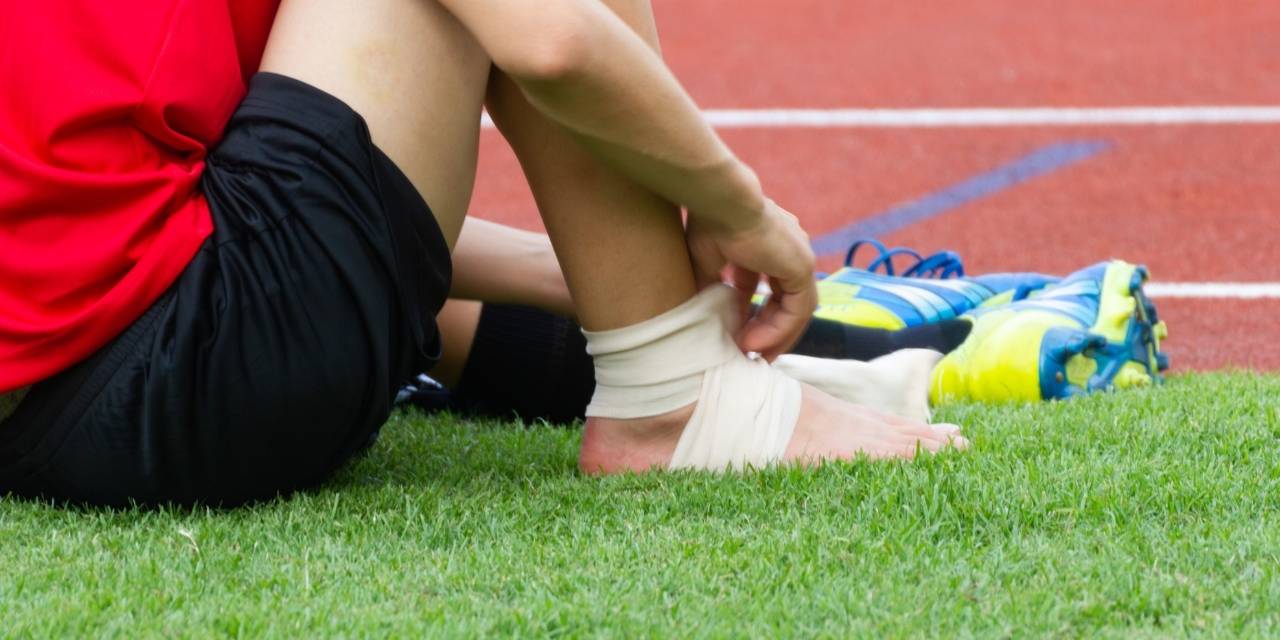 male athlete with ankle injury