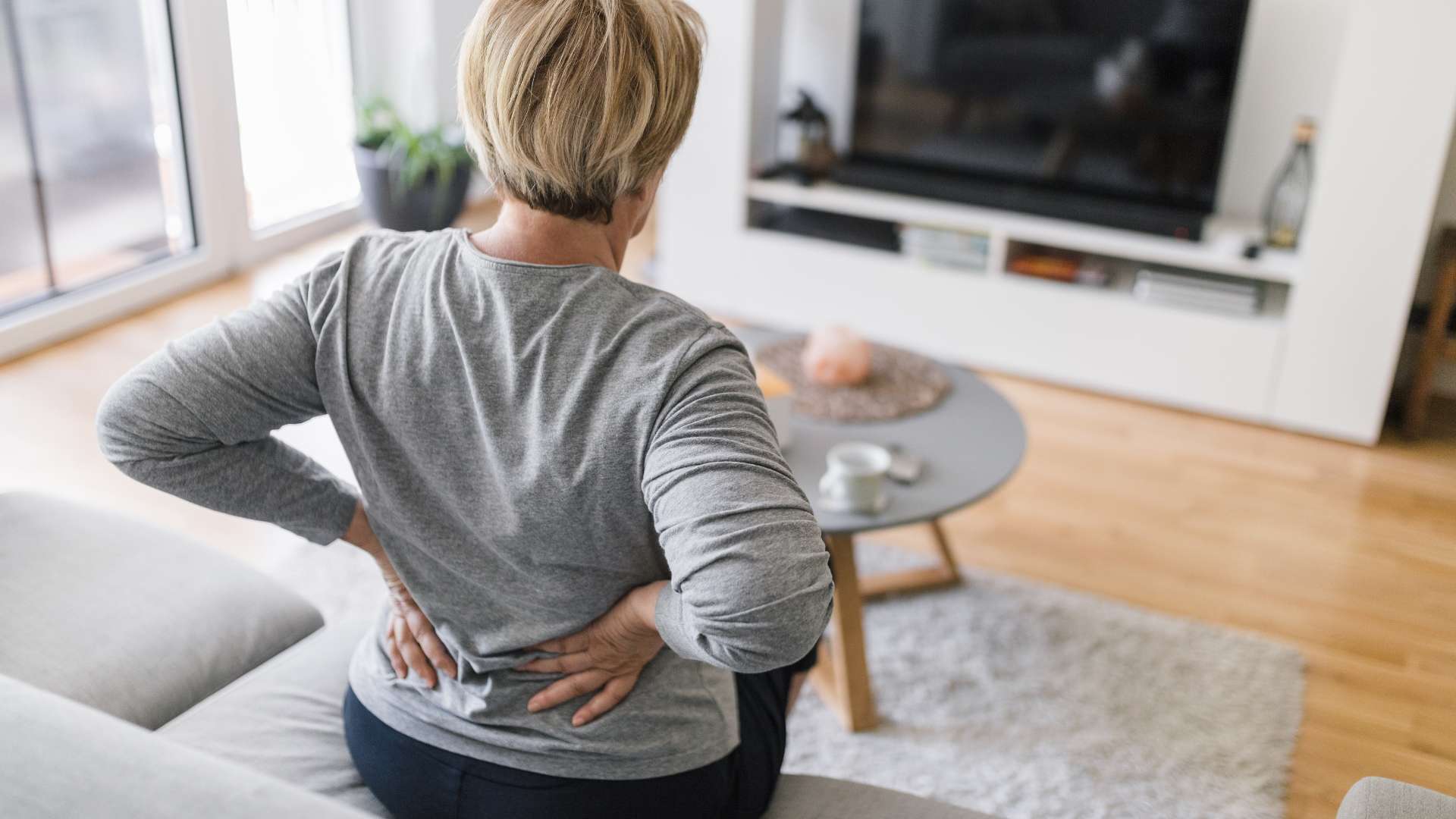 man holding knee with pain